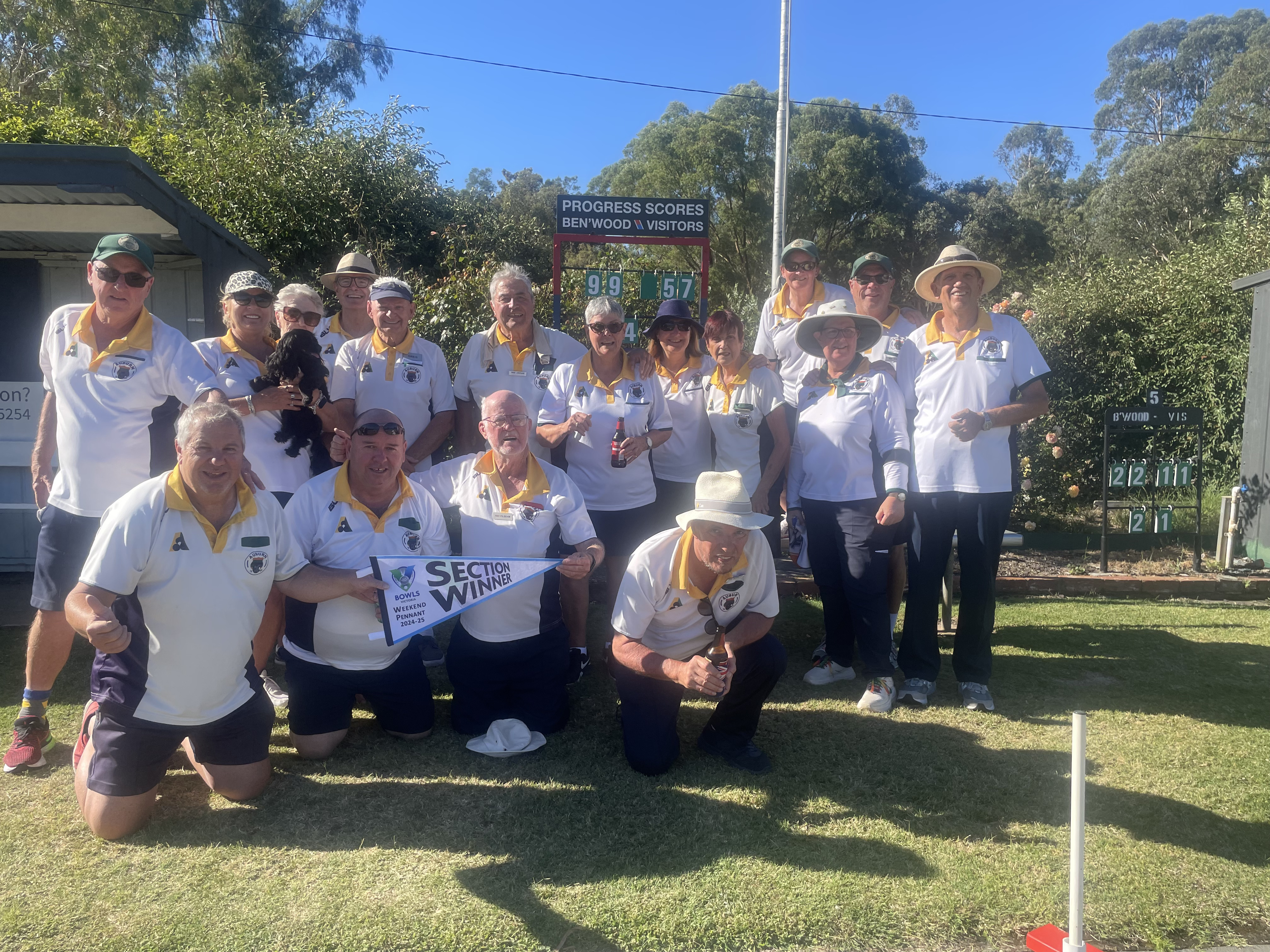 Auburn's Weekend Pennant team celebrating with their 2024-25 Section Winner pennant on the green